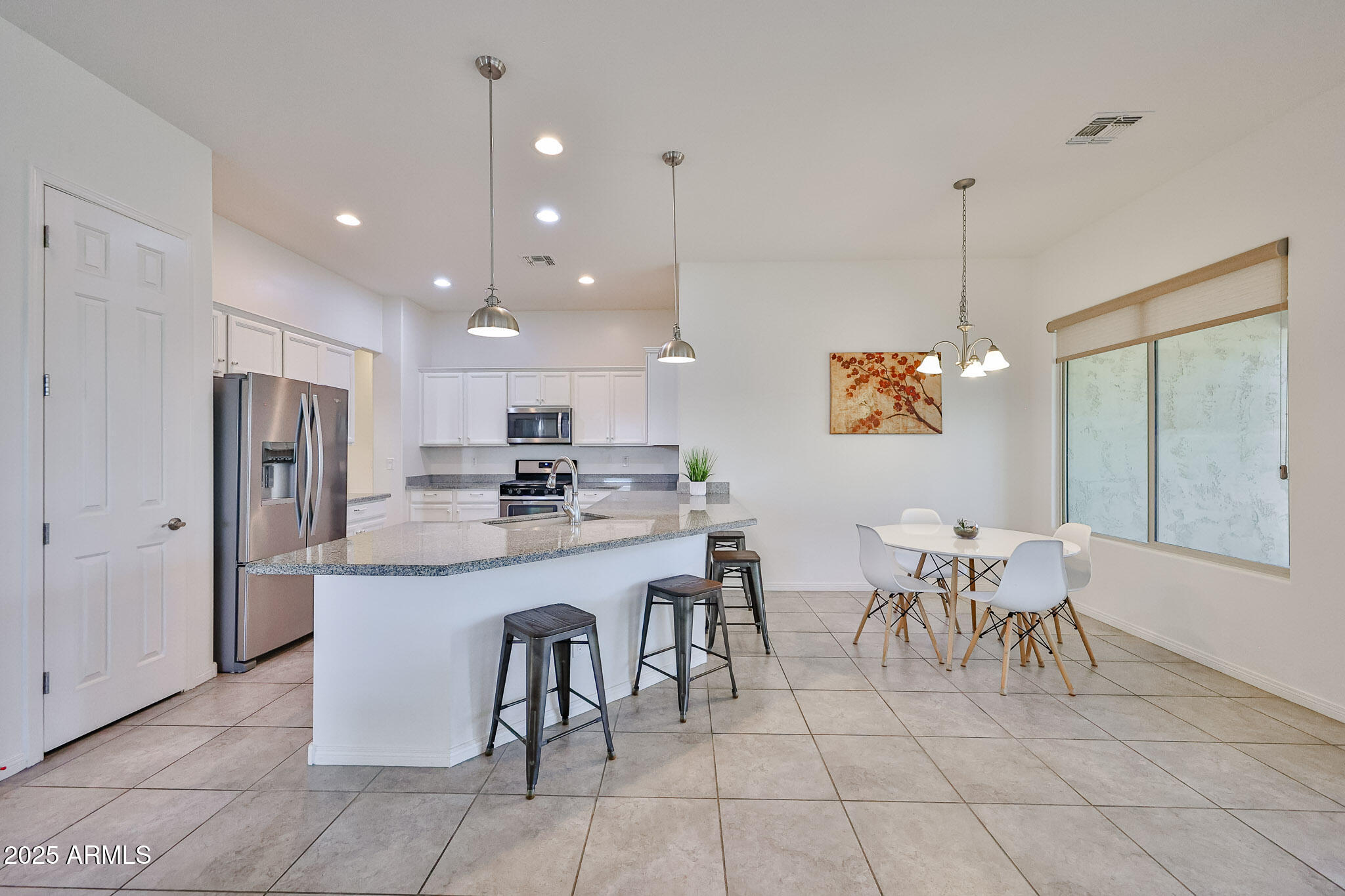 17082 South 182nd Avenue Goodyear, AZ 85338 - Photo 15 of 71 a large kitchen with a table and chairs
