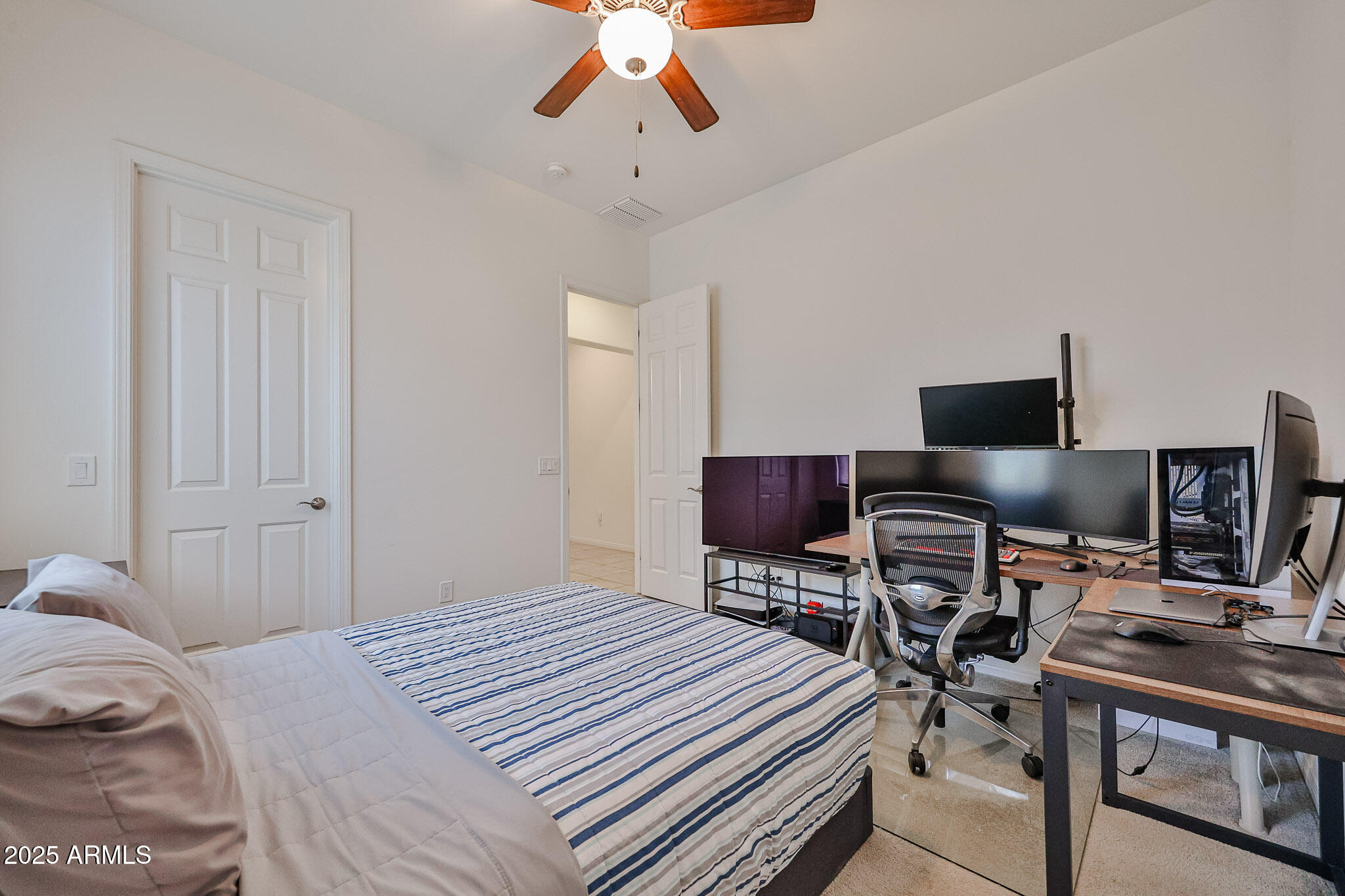 17082 South 182nd Avenue Goodyear, AZ 85338 - Photo 36 of 71 a bedroom that has a bed and a desk in it