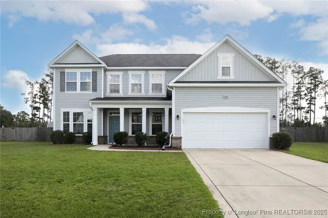 a front view of a house with a garden and plants