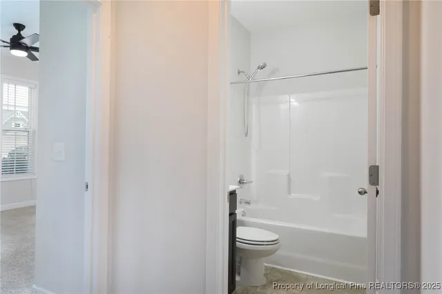 a bathroom with a shower a toilet and a shower