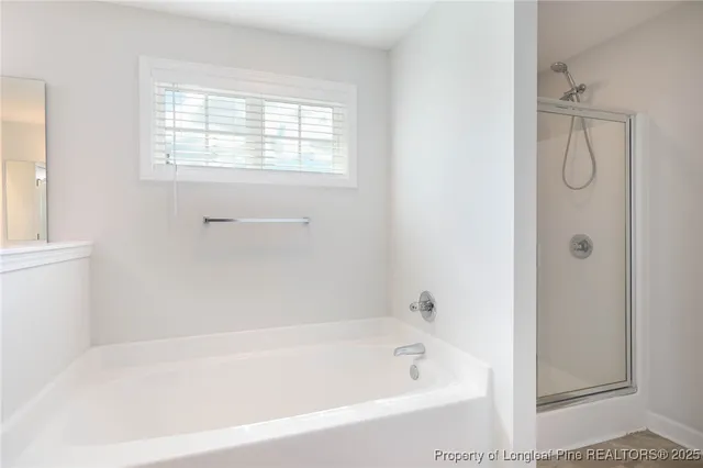 a white bath tub sitting next to a window