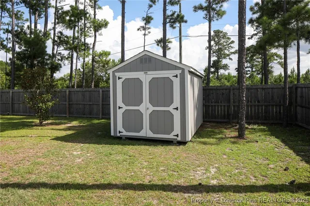 a view front of house with a yard and potted plants
