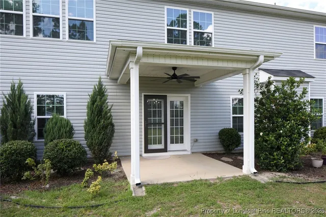 a view of a house with a yard and a porch