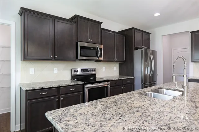 a kitchen with a sink stove and refrigerator