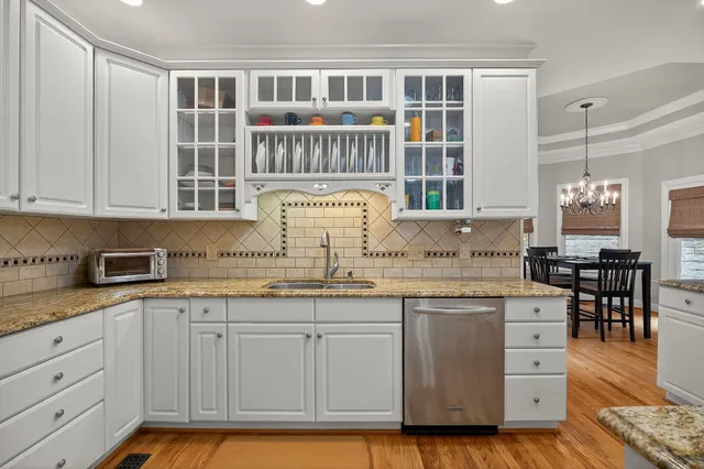 a kitchen with granite countertop a sink and cabinets