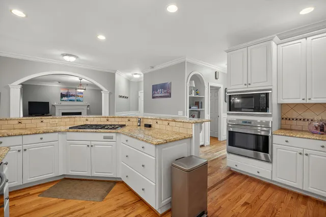 a kitchen with a sink stove and cabinets