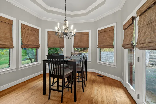 a view of a dining room with furniture window and wooden floor
