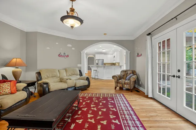a living room with furniture and a chandelier