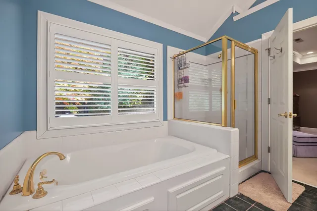 a bathroom with bathtub and window