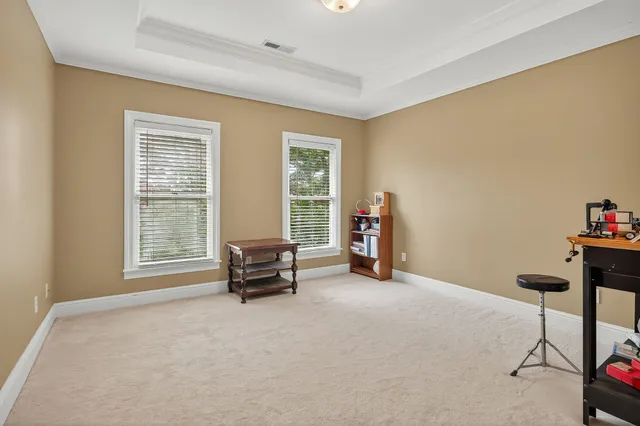 a view of a chair and table in backyard of the house