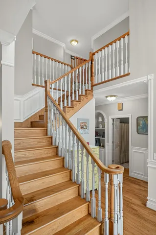 a view of entryway and hall with wooden floor