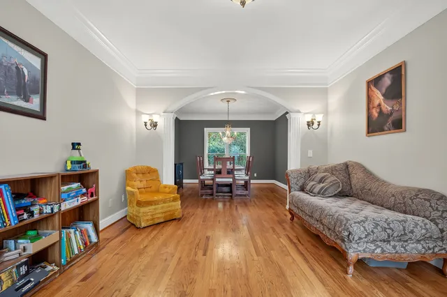 a living room with furniture and a book shelf