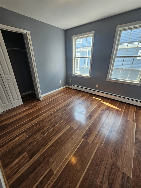 40 Merrick Street, Unit A Worcester, MA 01609 - Photo 24 of 32 a view of an empty room with wooden floor and a window