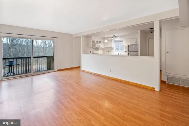 a view of a kitchen with wooden floor and electric appliances
