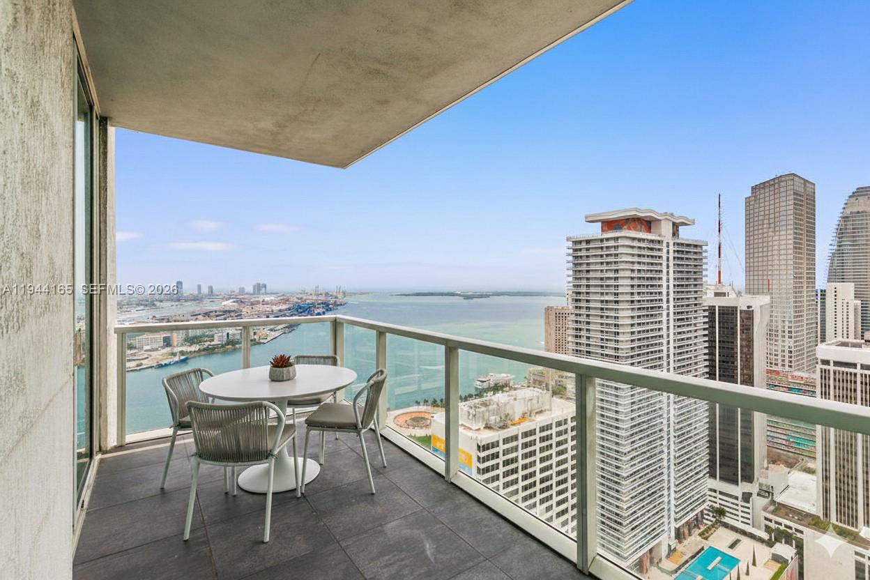 253 Northeast 2nd Street, Unit 4608 Miami, FL 33132 - Photo 2 of 37 a view of a balcony with wooden floor and furniture