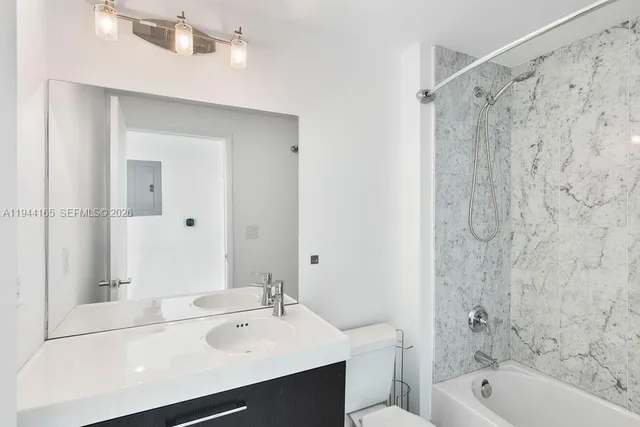 a bathroom with a shower and a sink