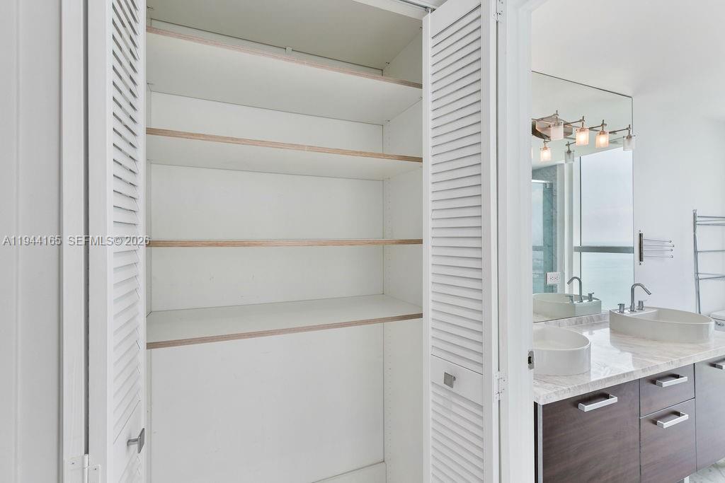 253 Northeast 2nd Street, Unit 4608 Miami, FL 33132 - Photo 30 of 37 a bathroom with a sink and a mirror