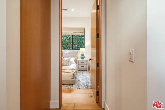 a bedroom with a bed next to a window with outer view