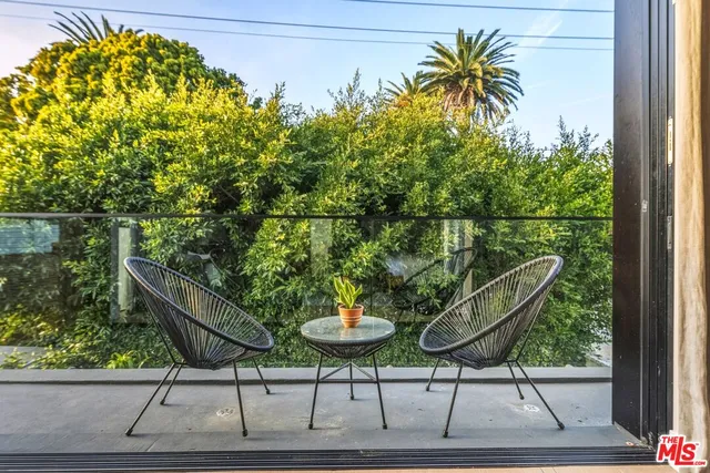 a bedroom with a bed and a night stand