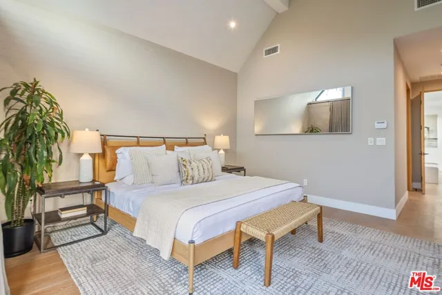 a bathroom with a granite countertop sink a mirror and shower