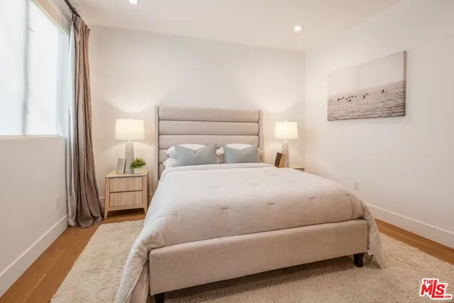 a bedroom with a large bed and a large window