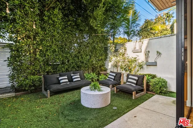 a view of a patio with couches and potted plants