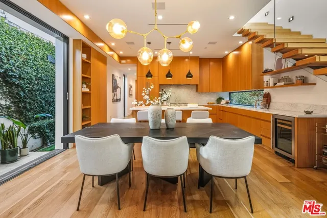 a dinning room with furniture and wooden floor
