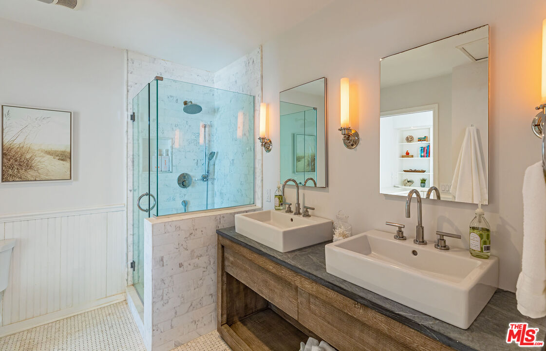 20828 Pacific Coast Highway Malibu, CA 90265 - Photo 13 of 23 a bathroom with a double vanity sink mirror and shower