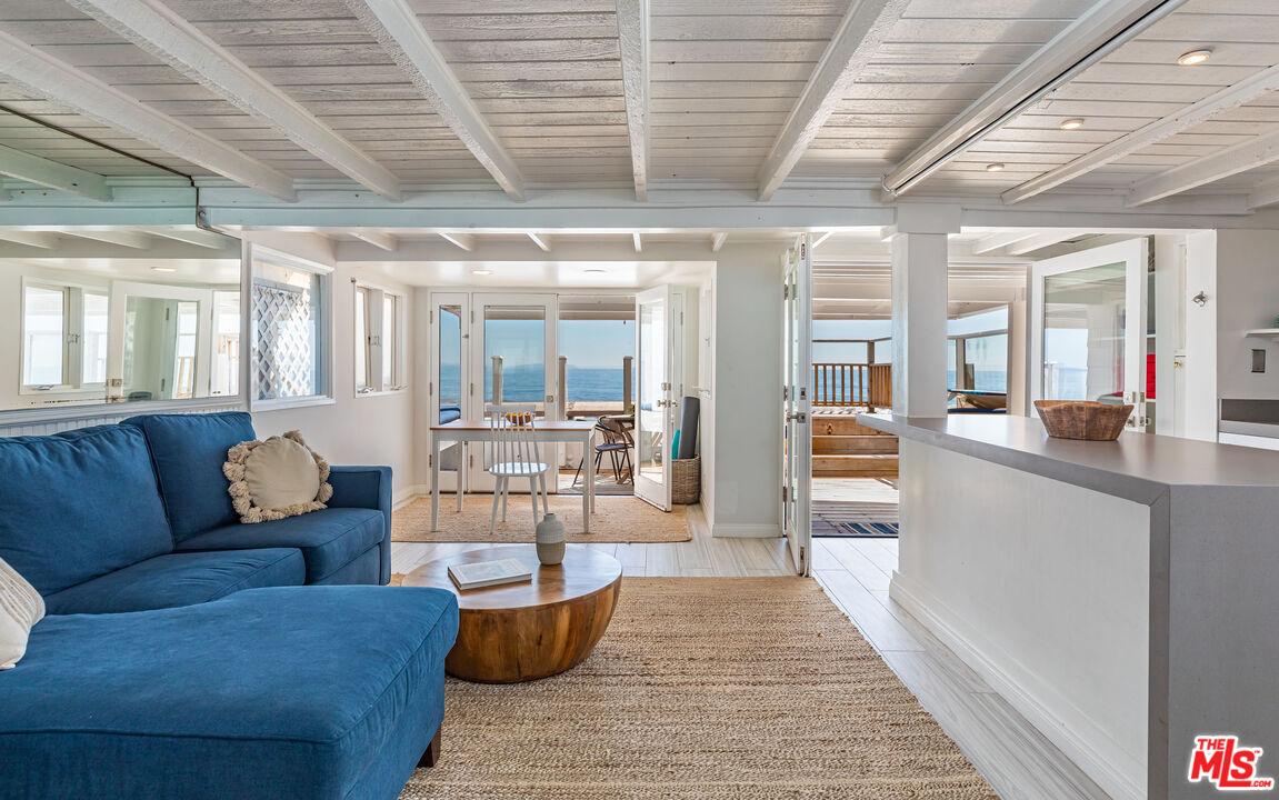 20828 Pacific Coast Highway Malibu, CA 90265 - Photo 17 of 23 a living room with furniture wooden floor and a fireplace
