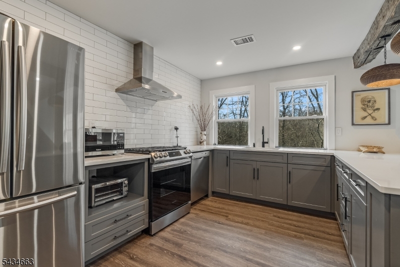 55 State Park Road Chester, NJ 07930 - Photo 33 of 48 a kitchen with stainless steel appliances granite countertop a stove and a refrigerator