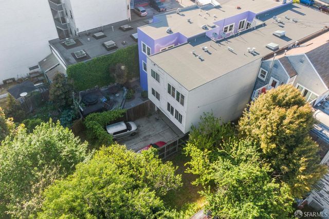 an aerial view of a house with a yard and potted plants