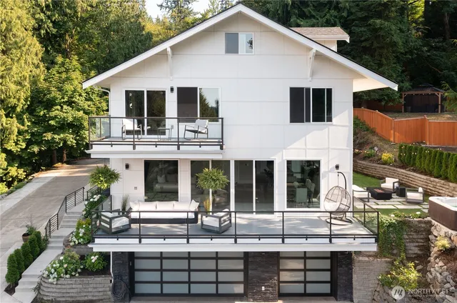 a view of white house with a chairs and table in a patio