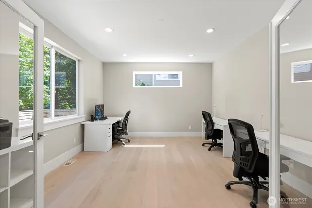 a view of a workspace with furniture and a window