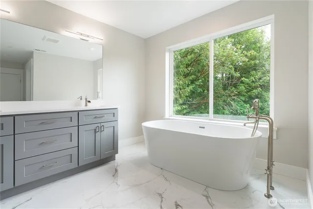 a spacious bathroom with a bathtub and sink