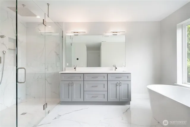 a bathroom with a double vanity sink mirror and shower