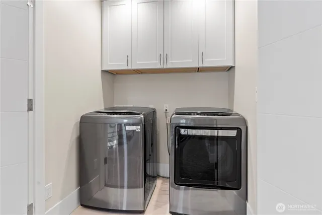 a view of storage and utility room with washer and dryer