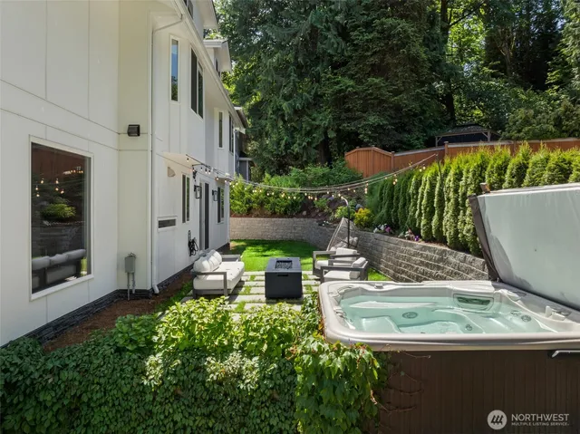 a view of a chairs and table in backyard of the house