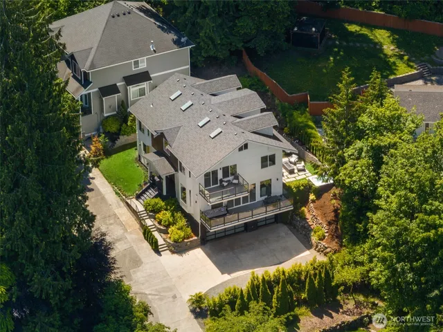 an aerial view of a house with a yard swimming pool and outdoor seating