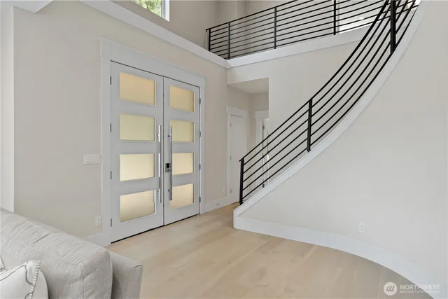 a view of entryway and hall with wooden floor