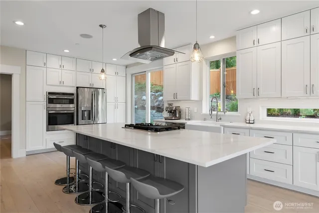 a kitchen with stainless steel appliances a sink window and cabinets