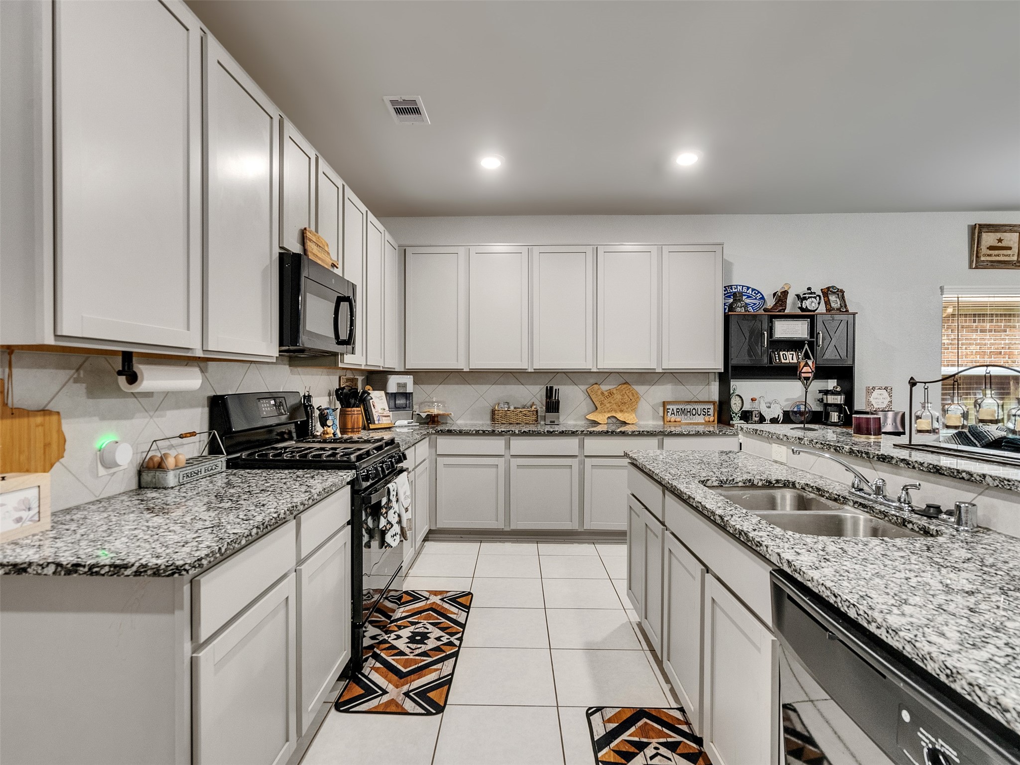 8719 Willet Street Baytown, TX 77521 - Photo 23 of 42 a kitchen with a sink stove and cabinets