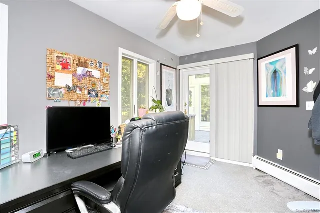 a workspace with furniture bookshelf and a window
