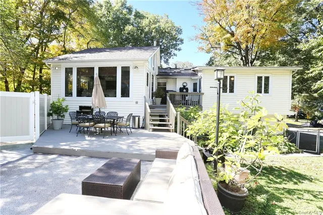 a view of a house with backyard porch and sitting area