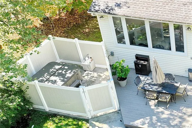a view of a house with backyard sitting area and garden