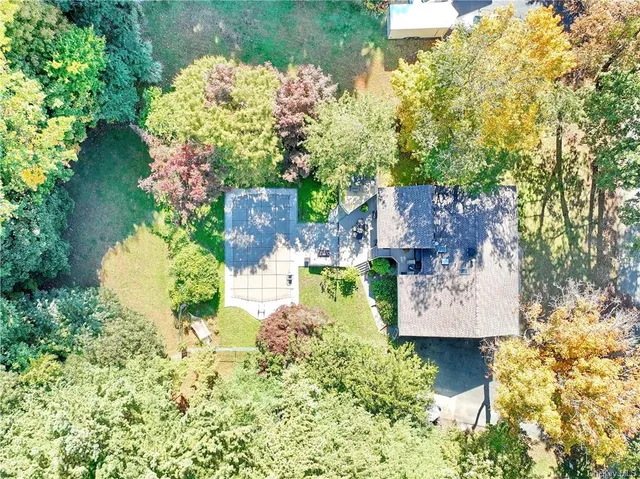 a aerial view of a house with a yard and garden
