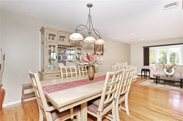 a view of a dining room with furniture wooden floor and chandelier