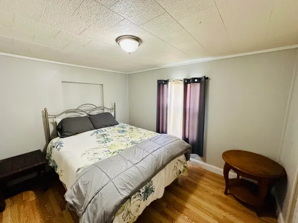 a view of a room with wooden floor and a chair