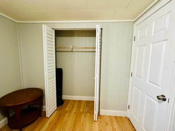 a bedroom with a bed and a walk in closet