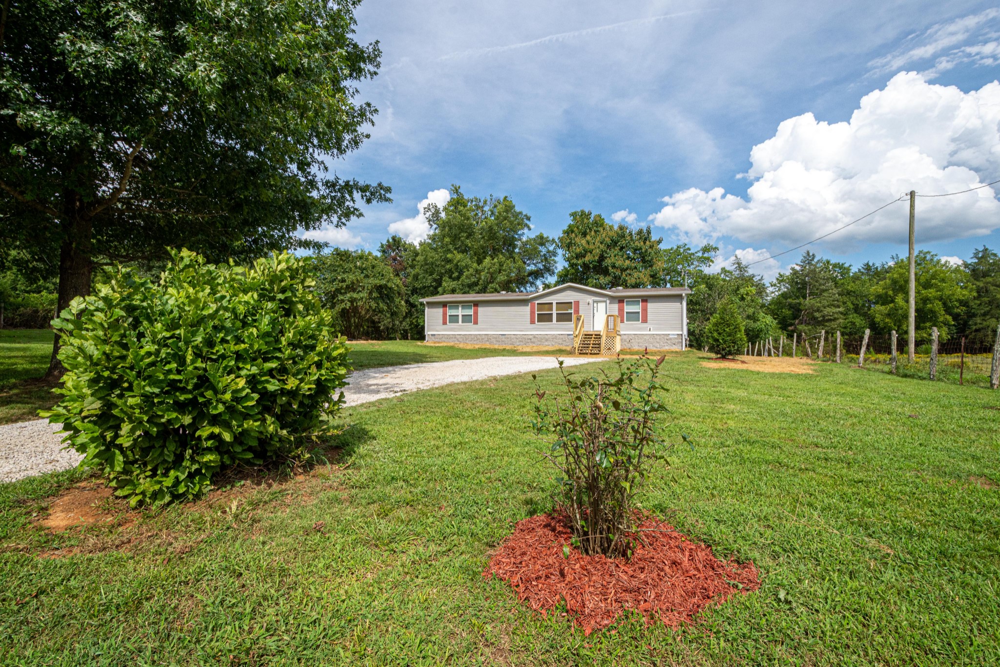 765 Crooked Hill Road Pulaski, TN 38478 - Photo 2 of 50 a view of a garden with a fountain