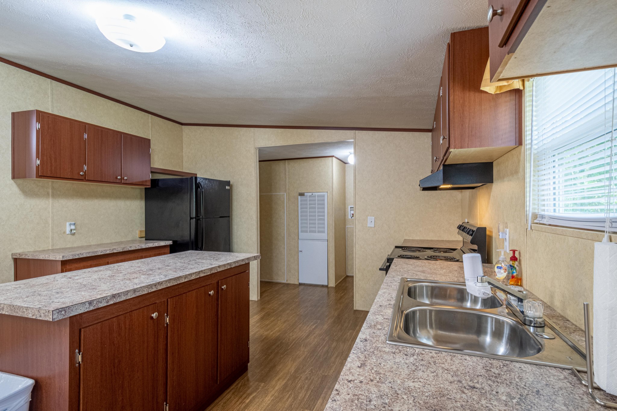 765 Crooked Hill Road Pulaski, TN 38478 - Photo 23 of 50 a kitchen that has a sink a refrigerator and a stove in it
